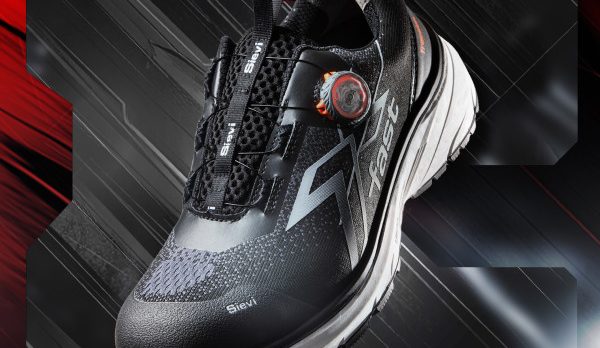 Black running shoe with a red dial/closure, gray panels, and a white sole shown at an angle against a red and black abstract background.